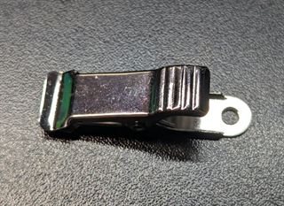 Stainless steel spring clip with a screw hole at one end