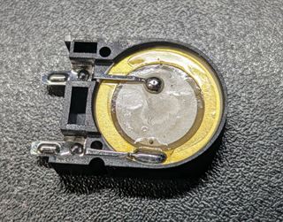 Passive piezo buzzer element with a brass disc and two solder tabs in a black holder