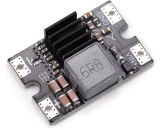 Small switching step-down regulator module with an inductor, heatsink fins and VIN and GND solder pads