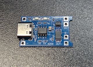 Blue TP4056 charging module with a USB-C socket, protection chip and B+ B- OUT+ OUT- pads